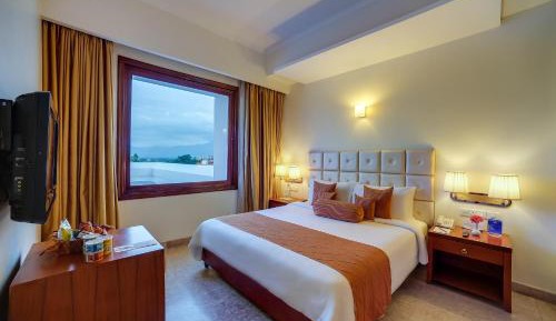 Suite Room - King Size Bed with Complimentary tea/coffee service for all our in-house guest at the poolside with some popular evening snacks of Siliguri from 5pm to 7pm